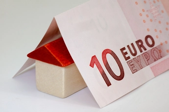10 Euro-Schein ist wie ein Dach über einem Haus aus 2 Bauklötzchen gefaltet.